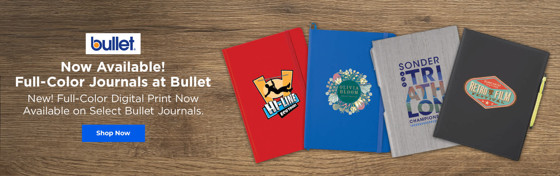 This banner shows three colorful custom notebooks displayed on a wooden surface, with the logo Bullet prominently placed in the center below the notebooks