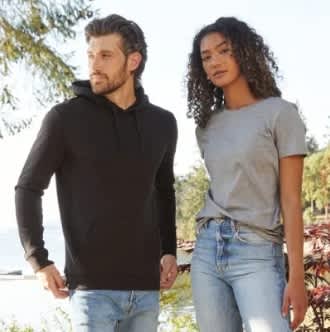 A man in a black hoodie and a woman in a grey t-shirt standing outdoors with trees in the background