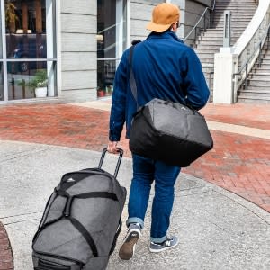 A man with a travaling bags image