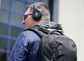 man with jacket, backpack and headphones