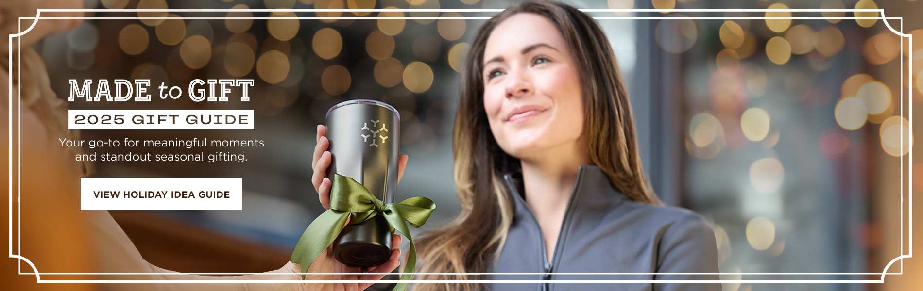 Woman receiving a branded tumbler gift, promoting the 2025 Gift Guide launch