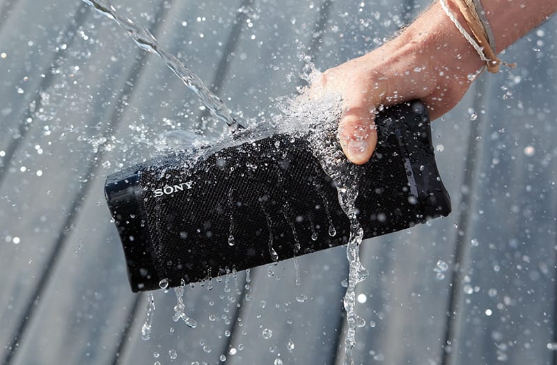 Sony speaker being held with water being poured on it